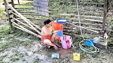 Topless Asian MILF washing outdoors porn clip